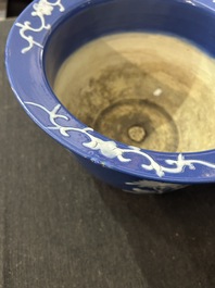 A Chinese white-slip-decorated blue-ground garden seat and two jardini&egrave;res, 19th C.