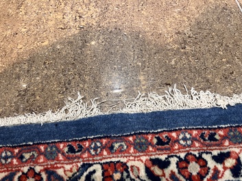 A Persian Sarouk rug with central medallion and floral design, wool on cotton, 20th C.