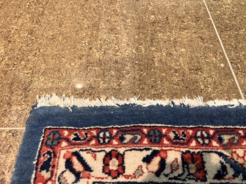 A Persian Sarouk rug with central medallion and floral design, wool on cotton, 20th C.