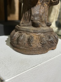 A Chinese cast iron sculpture of a Luohan, probably Ming