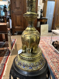 A reticulated Chinese wooden stand with marble top and a French gilt brass and champlev&eacute; 'elephant' lamp, 20th C.