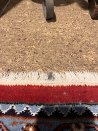 A Persian Bidjar rug with floral design, wool on cotton, 20th C.