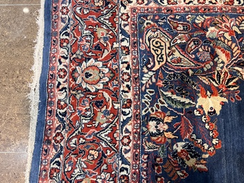 A Persian Sarouk rug with central medallion and floral design, wool on cotton, 20th C.