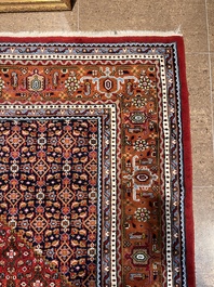 A Persian Bidjar rug with floral design, wool on cotton, 20th C.