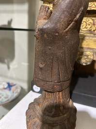 A Chinese cast iron sculpture of a Luohan, probably Ming