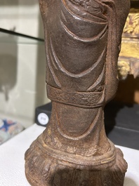 A Chinese cast iron sculpture of a Luohan, probably Ming