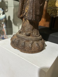 A Chinese cast iron sculpture of a Luohan, probably Ming