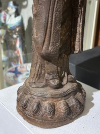 A Chinese cast iron sculpture of a Luohan, probably Ming