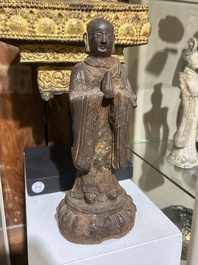 A Chinese cast iron sculpture of a Luohan, probably Ming