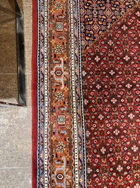 A Persian Bidjar rug with floral design, wool on cotton, 20th C.