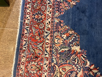A Persian Sarouk rug with central medallion and floral design, wool on cotton, 20th C.