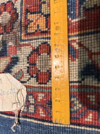 A Persian Sarouk rug with central medallion and floral design, wool on cotton, 20th C.