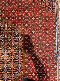 A Persian Bidjar rug with floral design, wool on cotton, 20th C.