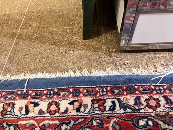 A Persian Sarouk rug with central medallion and floral design, wool on cotton, 20th C.