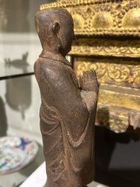 A Chinese cast iron sculpture of a Luohan, probably Ming