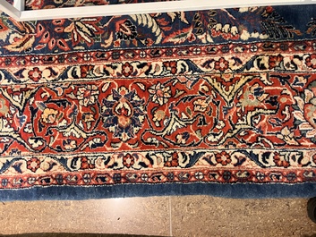 A Persian Sarouk rug with central medallion and floral design, wool on cotton, 20th C.