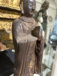 A Chinese cast iron sculpture of a Luohan, probably Ming