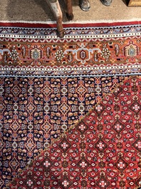 A Persian Bidjar rug with floral design, wool on cotton, 20th C.