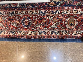 A Persian Sarouk rug with central medallion and floral design, wool on cotton, 20th C.