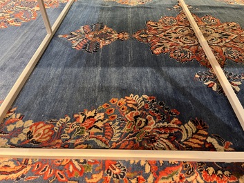 A Persian Sarouk rug with central medallion and floral design, wool on cotton, 20th C.