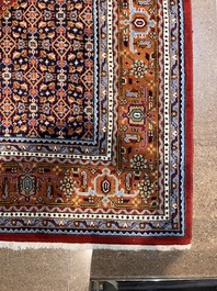 A Persian Bidjar rug with floral design, wool on cotton, 20th C.