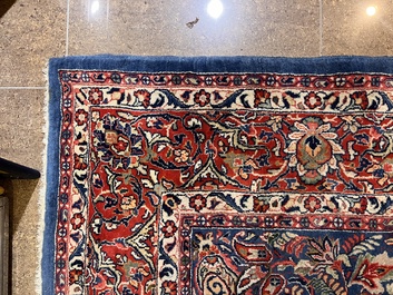 A Persian Sarouk rug with central medallion and floral design, wool on cotton, 20th C.