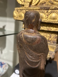 A Chinese cast iron sculpture of a Luohan, probably Ming