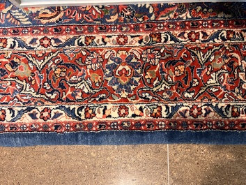 A Persian Sarouk rug with central medallion and floral design, wool on cotton, 20th C.