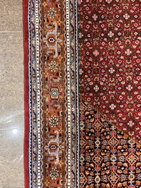 A Persian Bidjar rug with floral design, wool on cotton, 20th C.