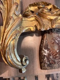 A pair of French carved gilt wooden Louis XV consoles with marble tops, 18th C.