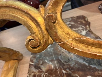 A pair of French carved gilt wooden Louis XV consoles with marble tops, 18th C.
