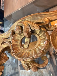 A pair of French carved gilt wooden Louis XV consoles with marble tops, 18th C.