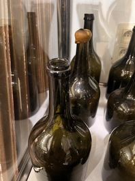 Sixteen Dutch and Flemish green glass wine bottles, 17th/19th C.