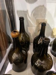 Sixteen Dutch and Flemish green glass wine bottles, 17th/19th C.