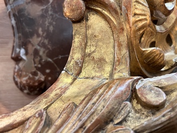A pair of French carved gilt wooden Louis XV consoles with marble tops, 18th C.