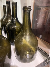 Sixteen Dutch and Flemish green glass wine bottles, 17th/19th C.