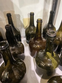 Sixteen Dutch and Flemish green glass wine bottles, 17th/19th C.