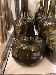 Sixteen Dutch and Flemish green glass wine bottles, 17th/19th C.