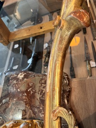 A pair of French carved gilt wooden Louis XV consoles with marble tops, 18th C.