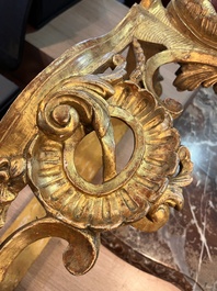 A pair of French carved gilt wooden Louis XV consoles with marble tops, 18th C.