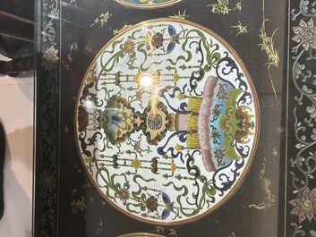 A Chinese rectangular lacquered wooden table with three cloisonn&eacute; plaques, 20th C.