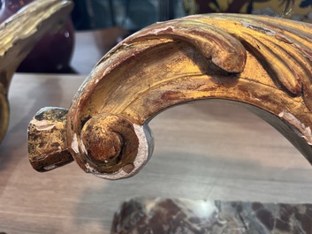 A pair of French carved gilt wooden Louis XV consoles with marble tops, 18th C.