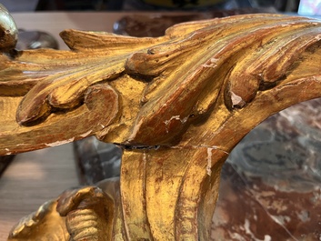 A pair of French carved gilt wooden Louis XV consoles with marble tops, 18th C.