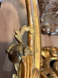 A pair of French carved gilt wooden Louis XV consoles with marble tops, 18th C.