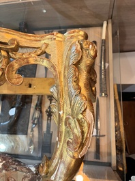 A pair of French carved gilt wooden Louis XV consoles with marble tops, 18th C.