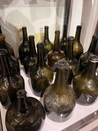 Sixteen Dutch and Flemish green glass wine bottles, 17th/19th C.