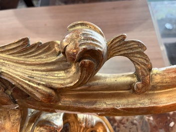 A pair of French carved gilt wooden Louis XV consoles with marble tops, 18th C.