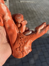 A Chinese red coral group with a scholar, his servant and a monkey, two-character mark, 19th C.