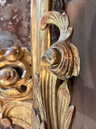 A pair of French carved gilt wooden Louis XV consoles with marble tops, 18th C.