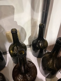 Sixteen Dutch and Flemish green glass wine bottles, 17th/19th C.